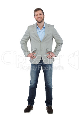 Stylish man smiling with hands on hips looking at camera