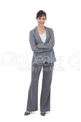 Young businesswoman with arms crossed smiling at camera