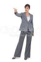 Young businesswoman pointing to something