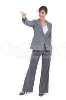 Young happy businesswoman pointing to something