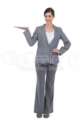 Smiling businesswoman holding tablet computer