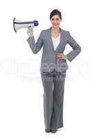 Smiling businesswoman holding loudspeaker