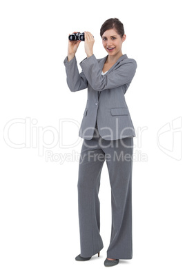 Businesswoman posing with binoculars