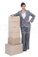 Smiling businesswoman with cardboard boxes