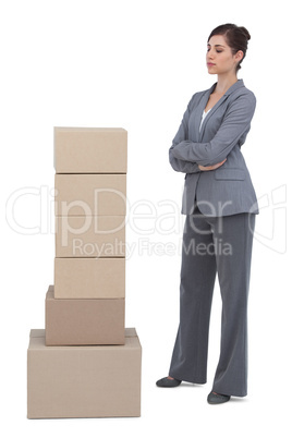 Thoughtful woman with cardboard boxes