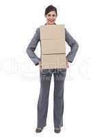 Smiling businesswoman carrying cardboard boxes