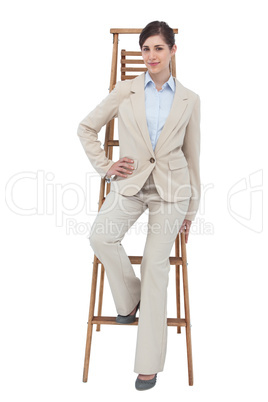 Businesswoman sitting on career ladder