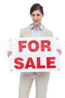 Businesswoman with for sale sign