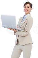 Cheerful businesswoman holding laptop