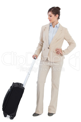 Confident businesswoman with suitcase