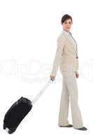 Businesswoman pulling suitcase