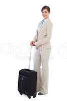 Cheerful businesswoman posing with suitcase