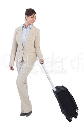 Classy businesswoman posing with suitcase