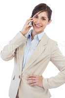 Cheerful businesswoman on the phone looking at camera