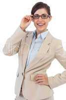 Smiling young businesswoman holding her glasses