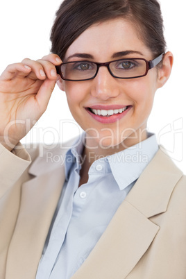 Cheerful businesswoman holding her glasses