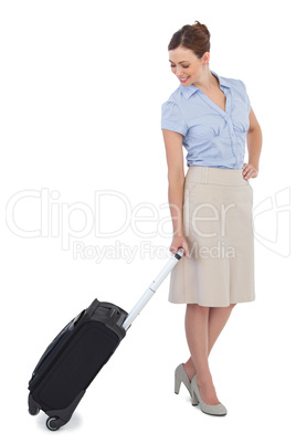 Classy businesswoman carrying suitcase