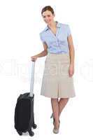 Elegant businesswoman posing with suitcase