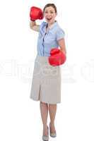 Cheerful businesswoman with red boxing gloves