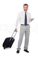 Businessman with phone and suitcase looking at camera