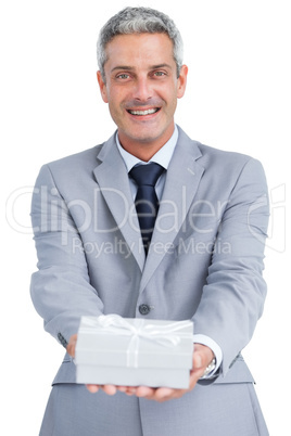 Elegant businessman holding gift