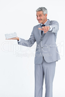 Confident businessman pointing at camera