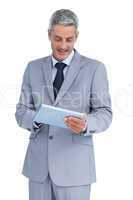 Happy businessman using tablet pc