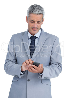 Businessman sending text message
