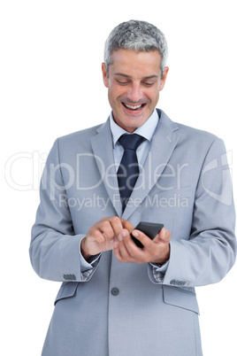 Happy businessman sending text message