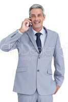 Happy businessman answering phone