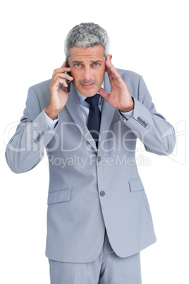 Concentrated businessman answering phone