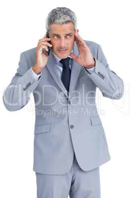 Attentive businessman answering phone