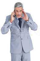 Attentive businessman answering phone