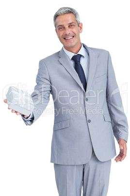 Good looking businessman offering gift