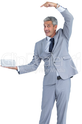 Funny businessman holding gift in right hand