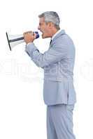 Furious businessman shouting in loudspeaker