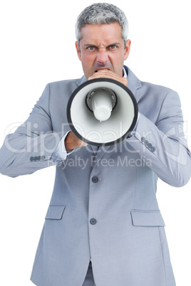Furious businessman posing with loudspeaker and looking at camer