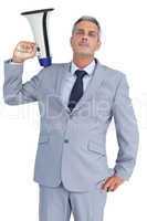 Businessman posing with loudspeaker on his shoulder