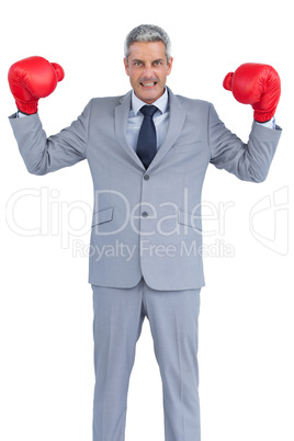 Businessman posing with red boxing gloves