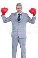 Businessman posing with red boxing gloves