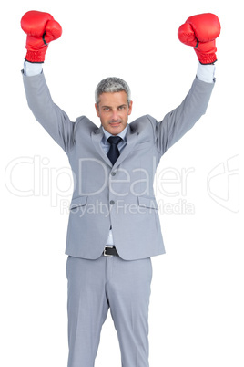 Businessman posing with red boxing gloves hands up