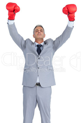 Cocky businessman posing with red boxing gloves