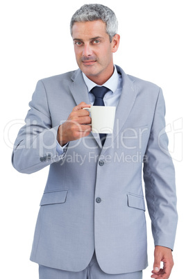 Businessman holding cup of coffee