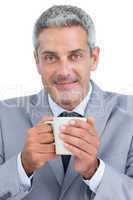 Content businessman holding mug