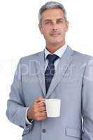 Confident businessman standing with coffee