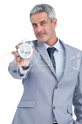 Businessman showing alarm clock