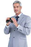 Businessman posing with binoculars