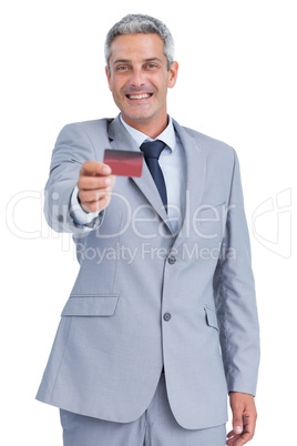 Handsome businessman holding credit card