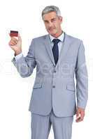 Handsome businessman showing credit card