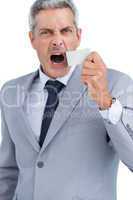 Businessman ripping off duct tape from mouth